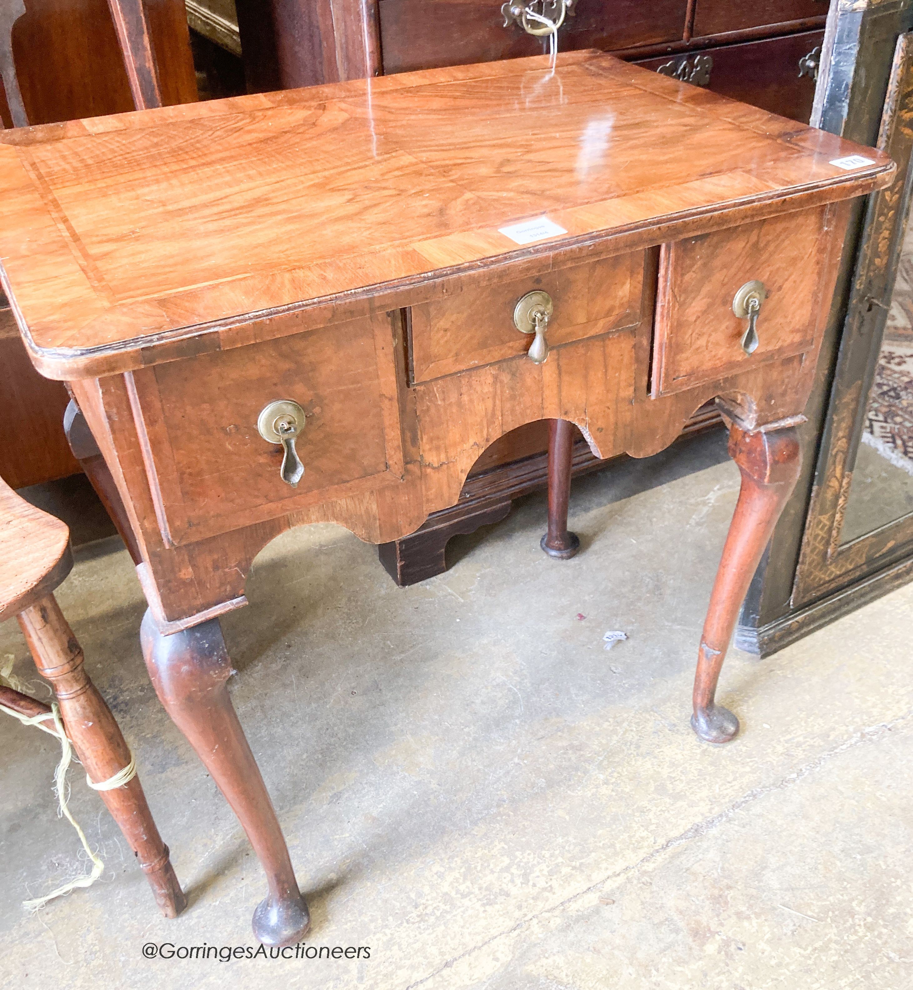 An early 18th century feather banded walnut three drawer lowboy, width 70cm, depth 48cm, height 70cm